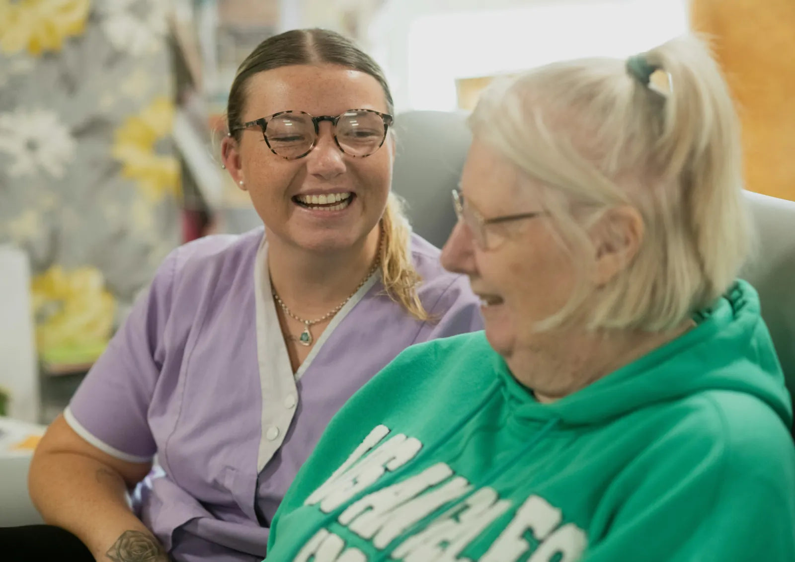 Caregiver and older adult sharing a warm conversation